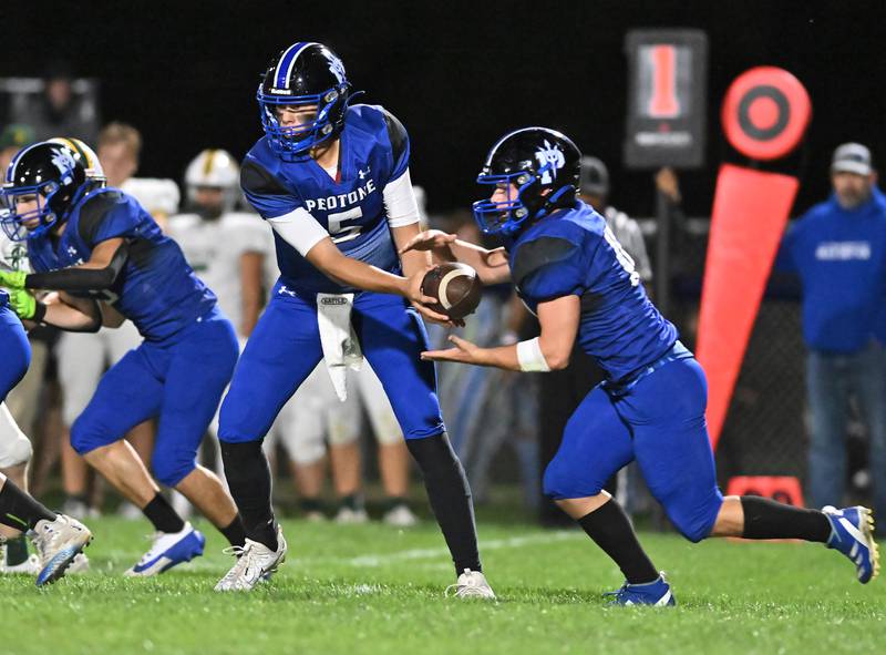 Peotone's Ruben Velasco hands the ball off to Connor Pasch during a conference game against Coal City on Friday, Sep 27, 2024 at Peotone. (Dean Reid for Shaw Local News)