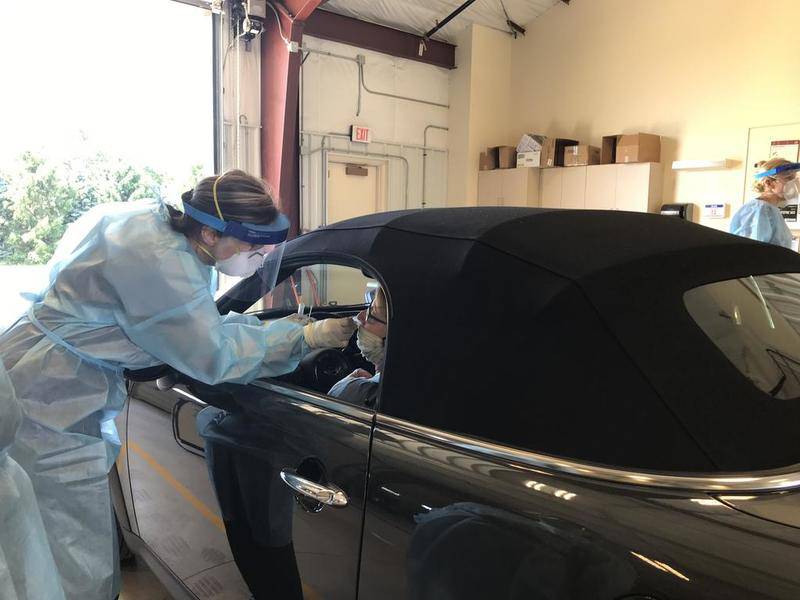 A nurse performs a COVID-19 test at the La Salle County Governmental Complex. The county is conducting drive-thru coronavirus tests by appointment. Tests are open to the public, regardless of symptoms. To schedule an appointment, call 815-433-3366.