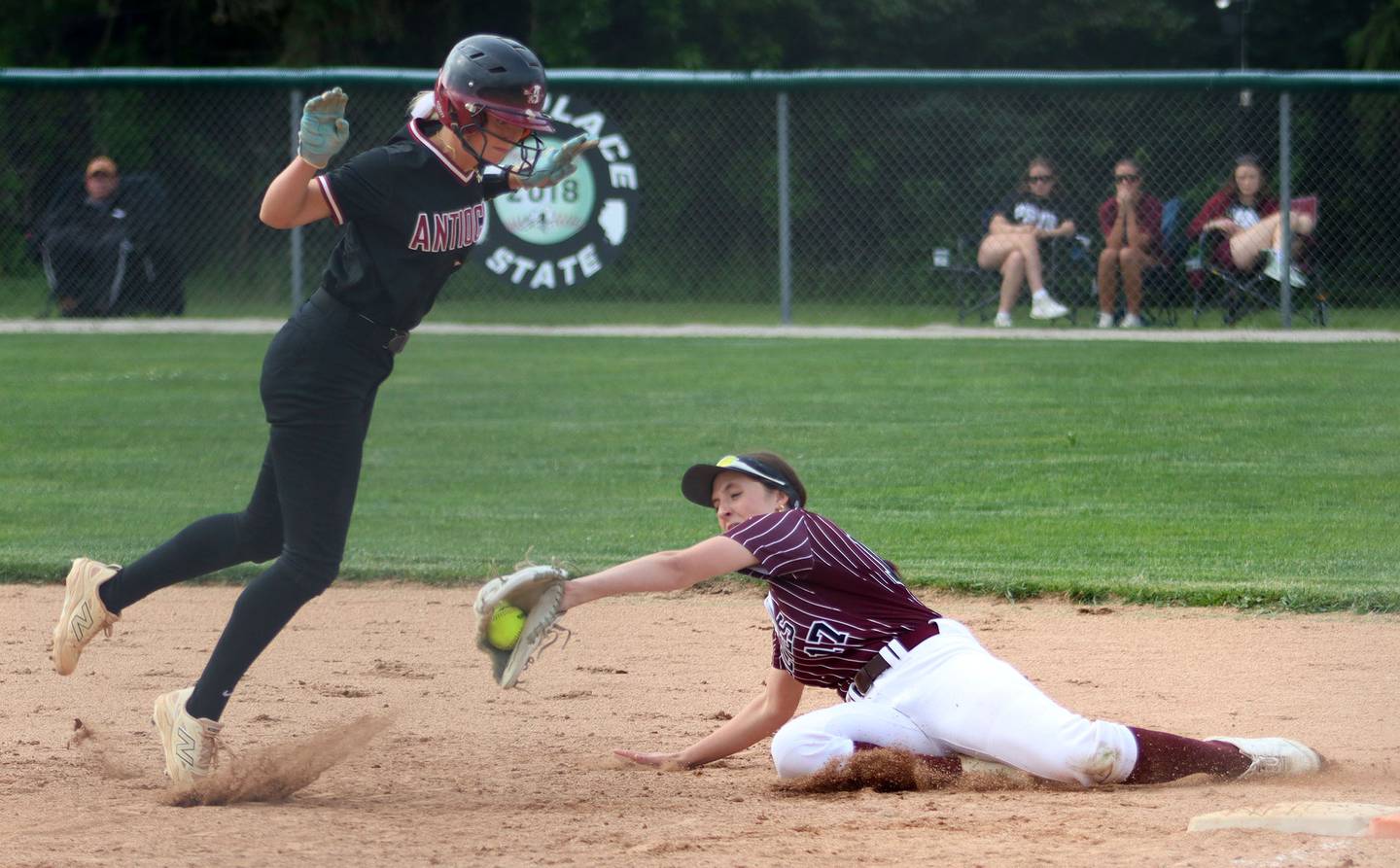 Antioch’s Claire Schulyer, left, avoids Prairie Ridge’s Parker Frey at first base in IHSA Class 3A Supersectional softball action at Kaneland High School in Maple Park on Monday, June 9, 2025.