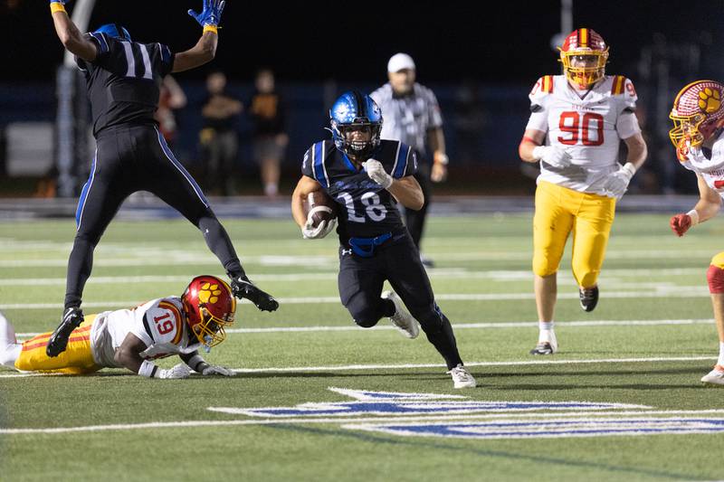St. Charles North's Carsen Durante runs the ball for a gain against Batavia on Friday, Sept. 26, 2025 in St. Charles.