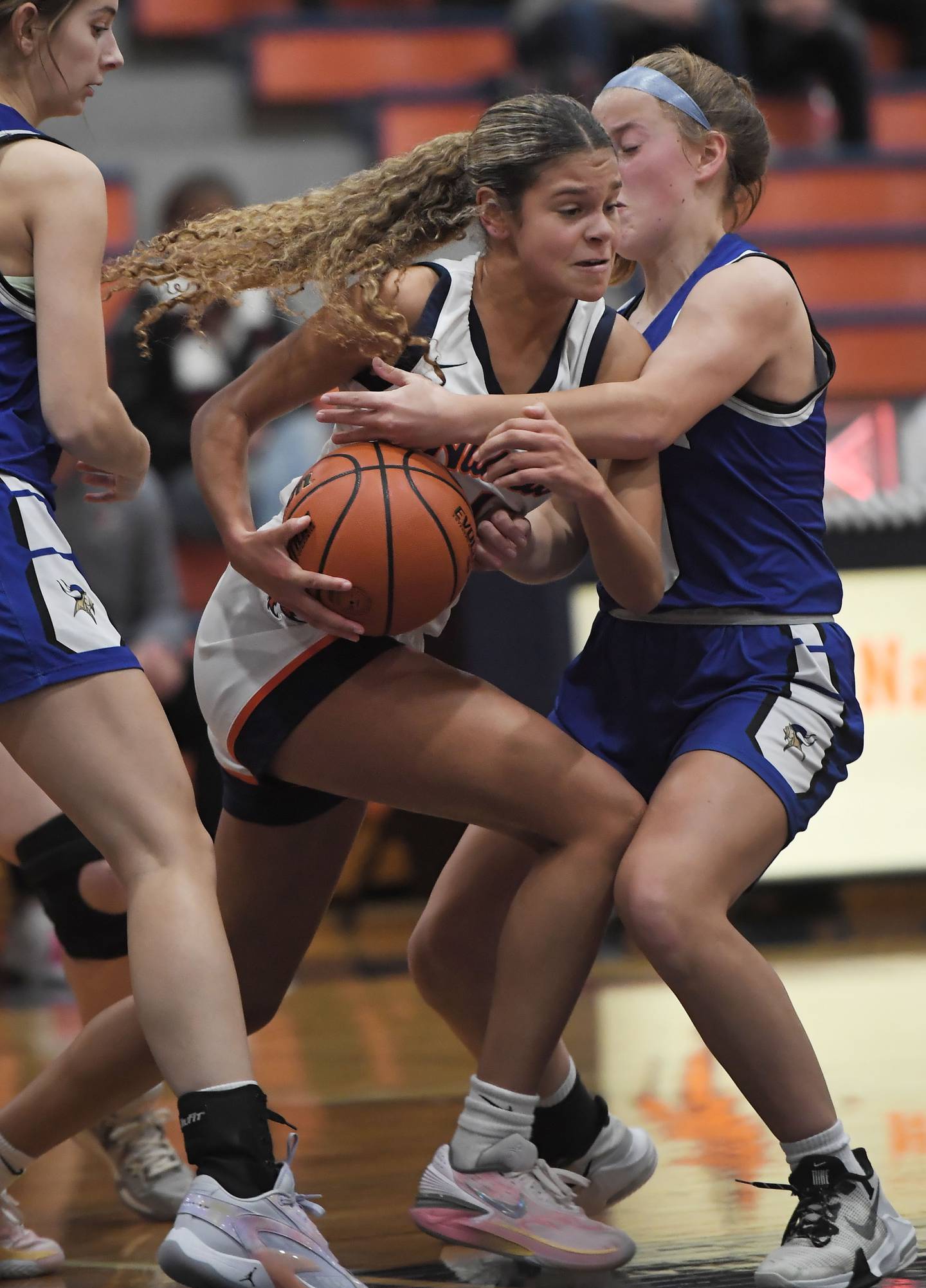 Naperville North’s Sydni Fink tries to get past Geneva’s Caroline Madden in a girls basketball game in Naperville on Tuesday, Nov. 28, 2023.
