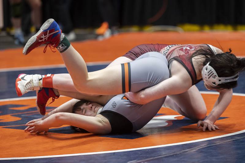 Ashlyn Strenz of Sandwich is flipped over by Avery Smith of Redbud in the 115 pound third place match at the IHSA girls state wrestling championship Saturday, Feb. 25, 2023.