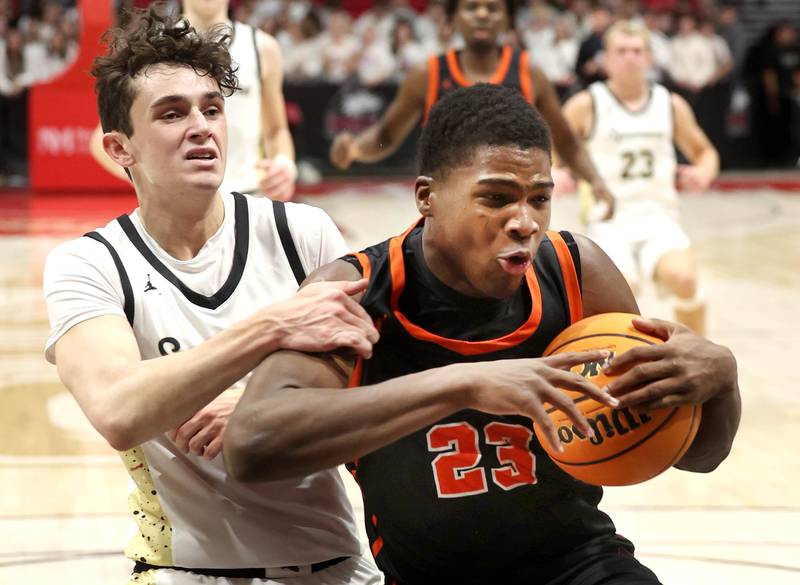DeKalb's Davon Grant secures the rebound in front of Sycamore's Jake Shipley during their game Friday, Jan. 31, 2025, in the FNBO Challenge in the Convocation Center at Northern Illinois University in DeKalb.