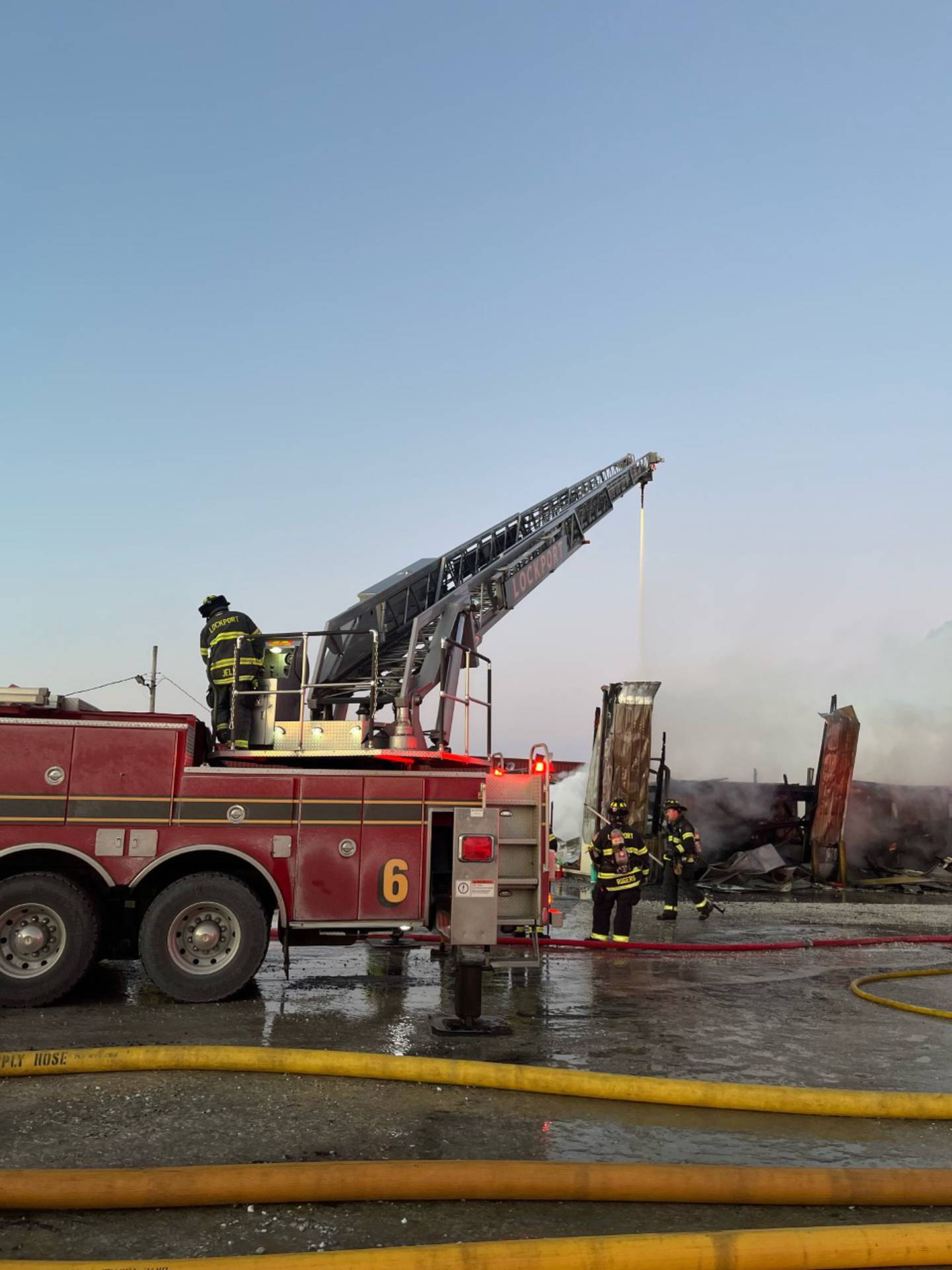 Firefighters battle a blaze on Dec. 24, 2022, at Gasnas Trucking in Lockport Township.
