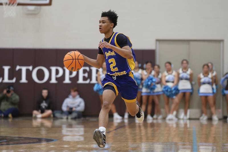 Joliet Central’s Kaden Henry works the ball upcourt against Joliet Catholic on Tuesday, Jan 20, 2026 in Joliet.