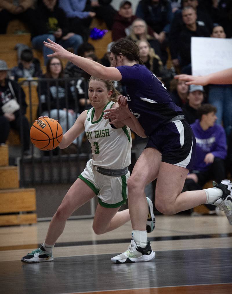 Seneca's Evelyn O'Connor, left, moves the ball toward the net around Manteno's Maddie Gesky during the IHSA Class 2A Beecher Regional championship Friday, Feb. 21, 2025.
