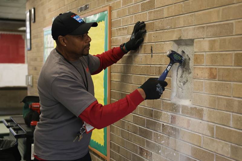 Anthony Brown Sr. breaks open a wall where they believe a time capsule was placed at Grompers Junior High School on Wednesday, May 1, 2026 in Joliet. In 1969 students placed items in a time capsule and sealed it inside a wall when an extension was built at Grompers Junior High School.