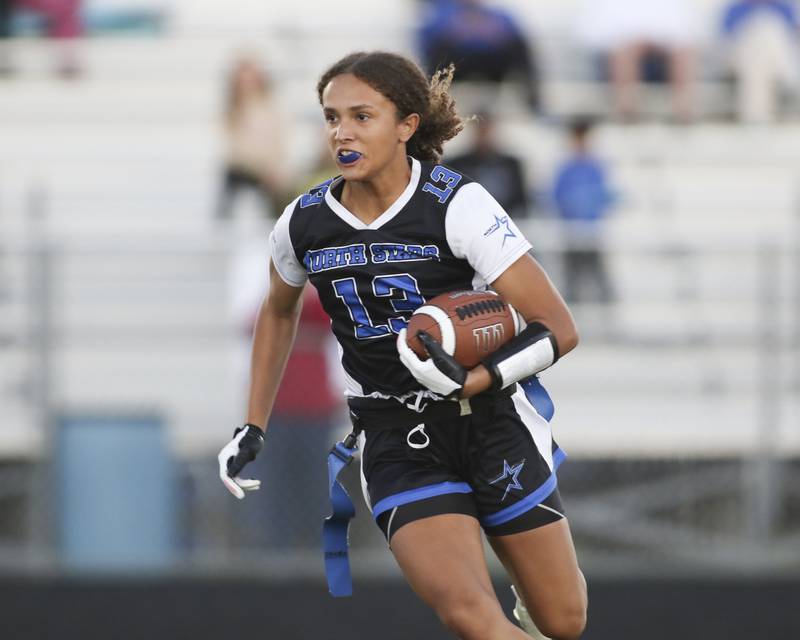 St. Charles North's Alexzandria Richardson (13) runs with the ball during Oswego East Regional Final flag football game between St. Charles North at Oswego East Thursday, Oct 9, 2025 in Oswego.