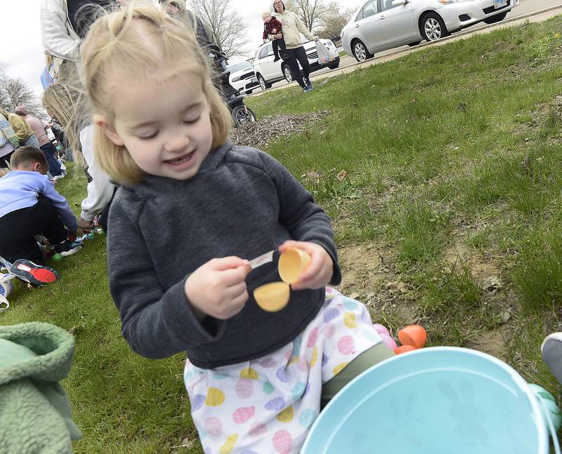 Vivian Arnold opens one of the eggs she found after the hunt to find a treat during the Easter Egg Hunt Saturday at Allen Park in Ottawa.