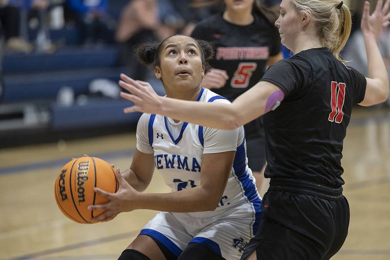 Newman’s Gisselle Martin works against Erie-Prophetstown’s Lauren Abbott Thursday, Dec. 12, 2024, at Newman High School.