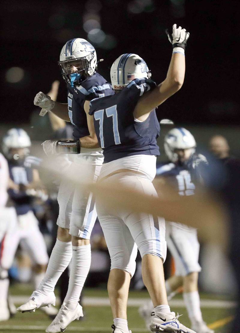Prospect's John Gavin (5) and Drew Heiss (77) celebrate a fumble recovery during the second round of the IHSA Class 7A Playoffs Friday November 4, 2022 in Mount Prospect.