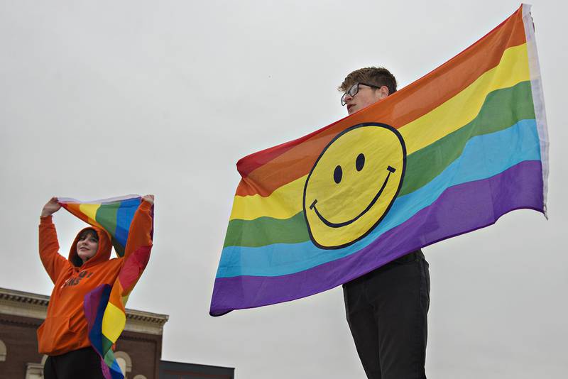 Kayden Carter (right), 15, holds a gay pride flag at the corner of First Street and Peoria Ave. Wednesday morning in Dixon. Carter was the subject of an assault Monday at Dixon High School which was recorded and distributed on social media. “The gay community at the school is scared, we just want out voices to be heard,” Carter said about the protest.