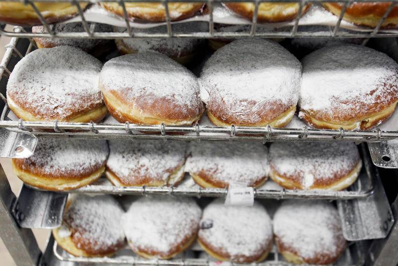 Trays of paczkis, a pre-Lenten Polish filled donut, with butter cream wait to be packaged up Feb. 13, 2015, at Country Donuts in Crystal Lake.