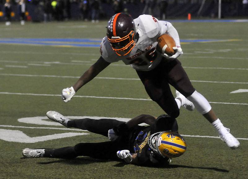 Brother Rice's Willie Shaw tries to get through the tackle of Warren's Matthew Slack in their Class 8A playoff semifinal game last season. Shaw committed to Toledo on Sunday.