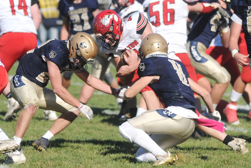 Marquette's Jurnee Reed (22) and Griffin Walker close in on Fulton's Keegan VanKampen at Gould Stadium on Saturday, Nov. 6, 2021.