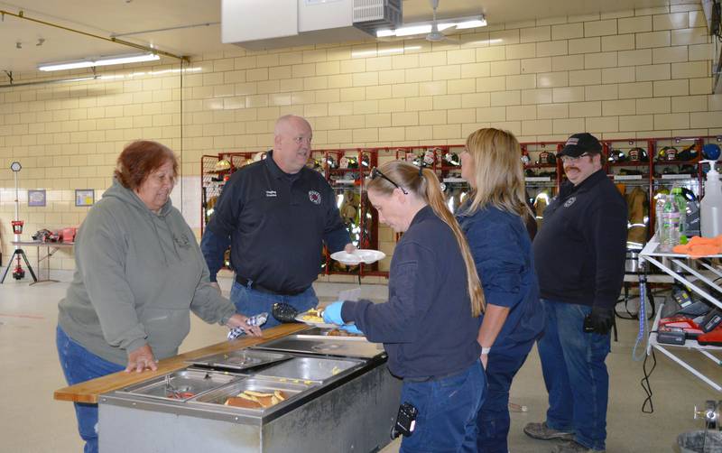 Roxanne Haas, left, and Polo firefighter Ken Yingling are served breakfast by firefighter Brian Carr, far right, paramedic April Rivers, center, and paramedic Sabrina Stock during the Polo Fire Protection District's annual spring breakfast fundraiser on April 30, 2023. The menu included biscuits and gravy, scrambled eggs, sausage links, pancakes, coffee and orange juice. A total of 479 people were served, and $4,202.17 raised to go toward the purchase of new equipment for the fire district.