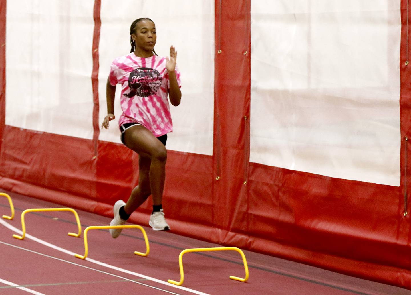 Alex Johnson runs a drill as she work out Monday, April 4, 2022, during track practice at Huntley High School The sisters are among the best long and triple jumpers in the state. Alex won long jump and Dominique won the triple jump at the indoor state meet this year.
