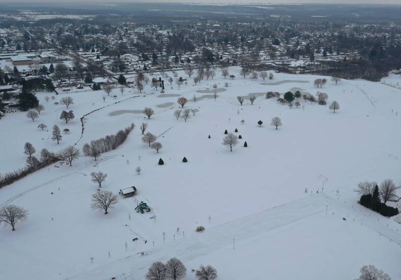 An aerial view of Baker Lake looking east on Tuesday, Dec. 9, 2025 in Peru. The concrete pathways have been poured but they will not be plowed this winter in order for the concrete to properly cure. Plowing the walkways to soon and applying salt could cause cracking and divots to the surface. Construction work began in early October and the park still remains closed to the public.