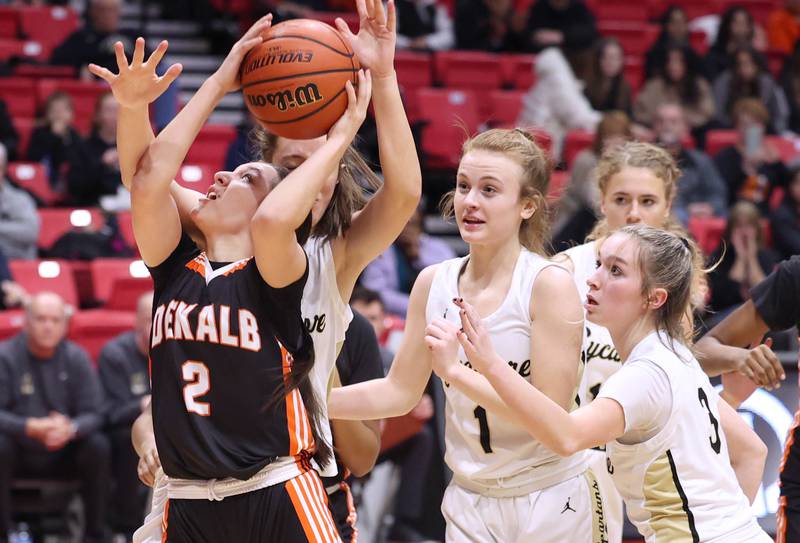 DeKalb's Ella Medina gets a shot off in front of a group of Sycamore defenders during the First National Challenge Friday, Jan. 27, 2023, at The Convocation Center on the campus of Northern Illinois University in DeKalb.