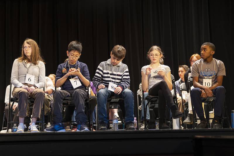 Spelling bee contestants spell out words as they wait their turn Thursday, Feb. 20, 2025, at the Lee, Ogle, Whiteside County Regional Spelling Bee.