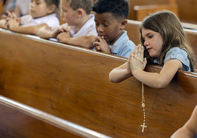 Maggie Shaddock, a student at St. Anne’s School, prays the rosary Wednesday, April 23, 2025, at St. Anne’s Church in Dixon. Students, staff and parishioners were invited in to pray for the recently deceased Pope Francis.