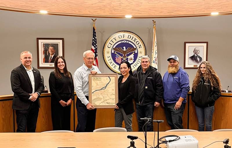 Surf representative Jennifer Alvarez presents Dixon Mayor Glen Hughes a commemorative plaque.