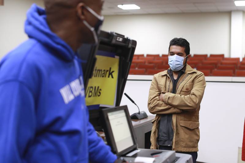 City council candidate Cesar Guerrero watches as votes are tabulated on Tuesday, April 20, 2021, at Will County Office Building in Joliet, Ill.