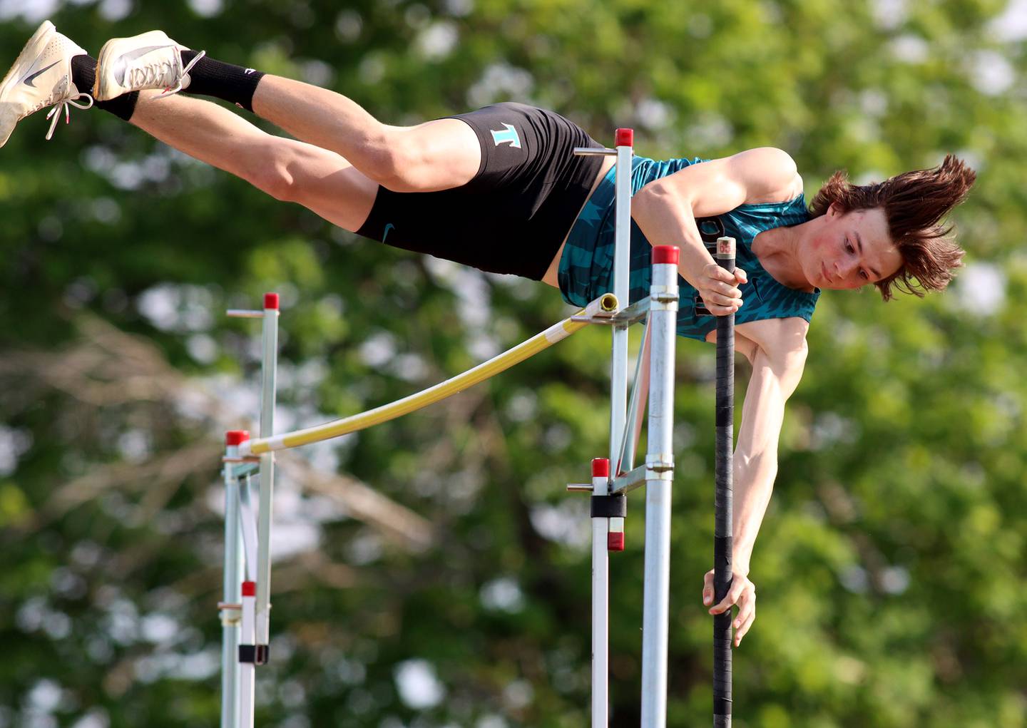 Woodstock North’s Landan Creighton competes in the pole vault during Kishwaukee River Conference track meet action at Marengo Tuesday night.