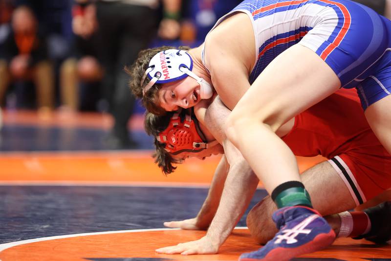 Marmion’s Tyler Perry works over Marist’s Jake Liberatore in the Class 3A 170lb. semifinals at State Farm Center in Champaign. Friday, Feb. 18, 2022, in Champaign.