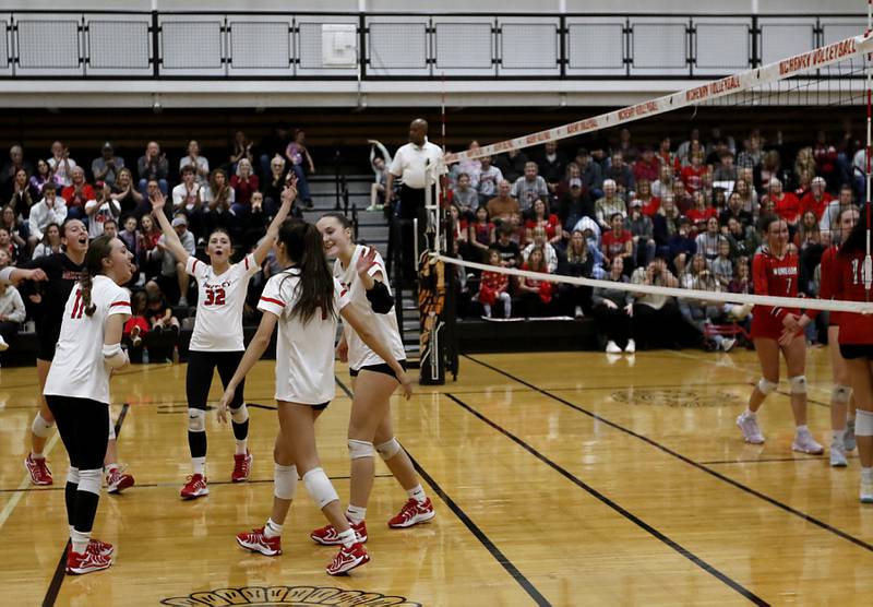 Huntley's Izzy Whitehouse and her teammates celebrate a point during an IHSA Class 4A McHenry Sectional volleyball match against Mundelein on Tuesday, Nov. 5, 2024, at McHenry High School Freshman Campus.