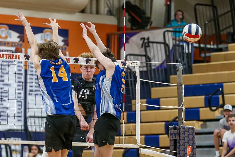 Downers Grove North's Cooper Hansen (13) spikes theball past the defense during Oswego Sectional final between Downers Grove North at Lyons.  May 30, 2023.