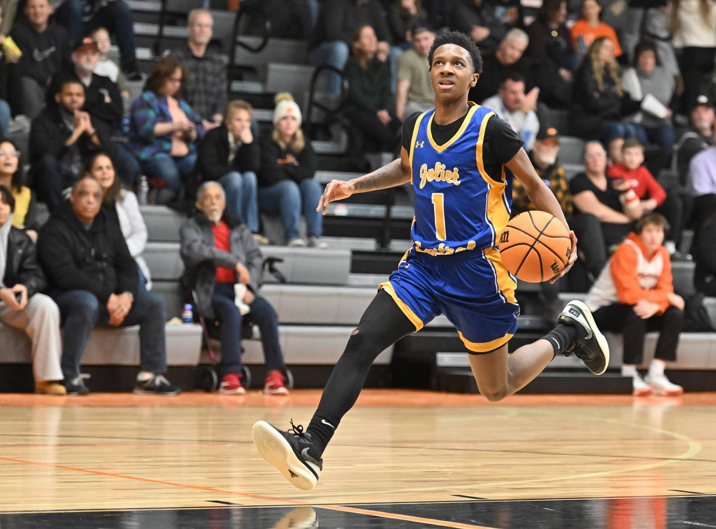 Joliet Central's Bernal Fox (1) drives to basket on a fast break during a conference game against Minooka on Friday, Jan. 10, 2025, at Minooka.