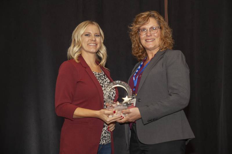 Ashley Speed (left) accepts her Women on the Rise Award at the Women in Banking Conference.