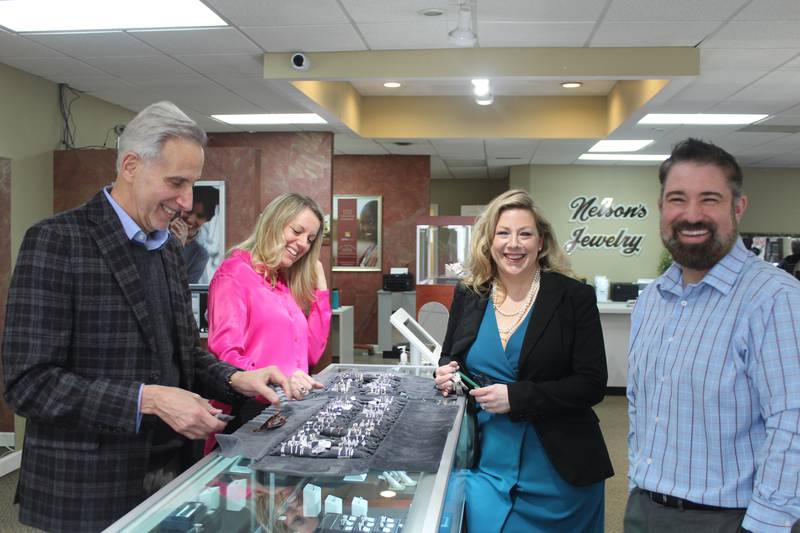Sam Gevisenheit, Nicole Treliving, Katie Caven and Justin Banaszynski showcase diamond engagement rings at Nelson's Jewelry in Crystal Lake.