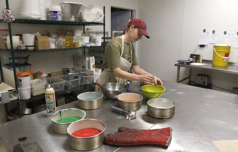 Corinna Bendel-Sac, the owner of Uprising Bakery and Cafe, 2104 Algonquin Road, in Lake in the Hills, makes a rainbow cake Thursday, July 14, 2022, at the bakery. UpRising, after announcing a drag show for Saturday, July 23, has faced an incredible amount of harassment and opposition.