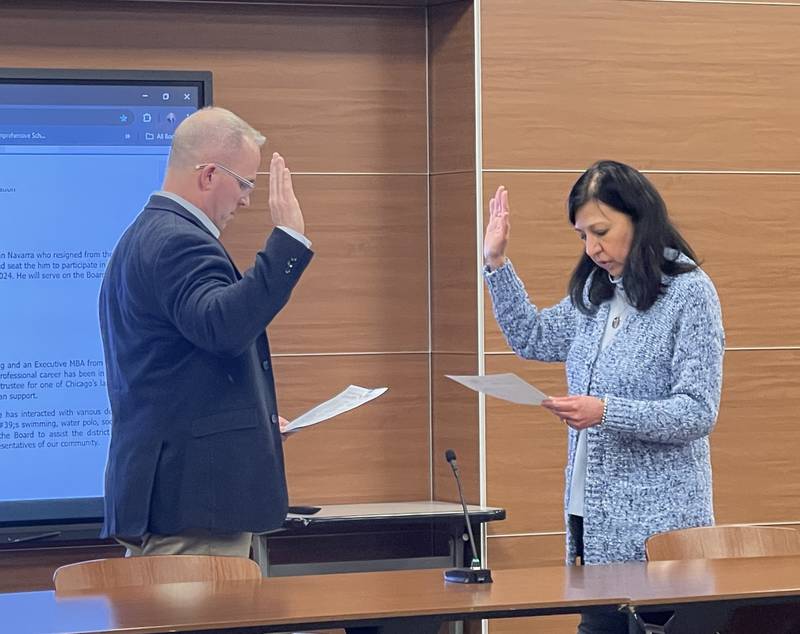 Derek Patton is sworn into office as an interim board of education member by Board President Ann Lopez-Caneva.
