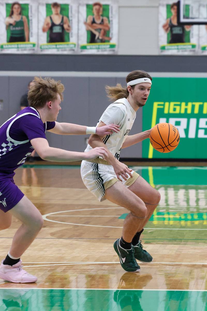 Bishop McNamara's Nolan Smith drives to the lane against Wilmington's Brodie Strong during Bishop McNamara's 61-24 victory over Wilmington in the IHSA Class 2A Seneca Sectional semifinal on Tuesday, March 3, 2026.