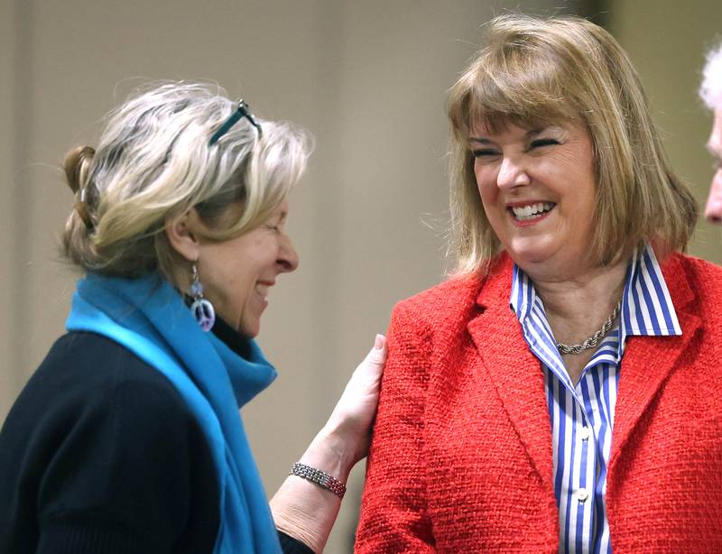 Barbara Larson, (right) DeKalb Second Ward Alderwoman who is running for re-election, has a laugh with Christine Kalina, of DeKalb, Wednesday, Feb. 19, 2025, at the DeKalb Area Rental Association and DeKalb Area Builders Association Candidate Night at Faranda's Banquet Center in DeKalb.