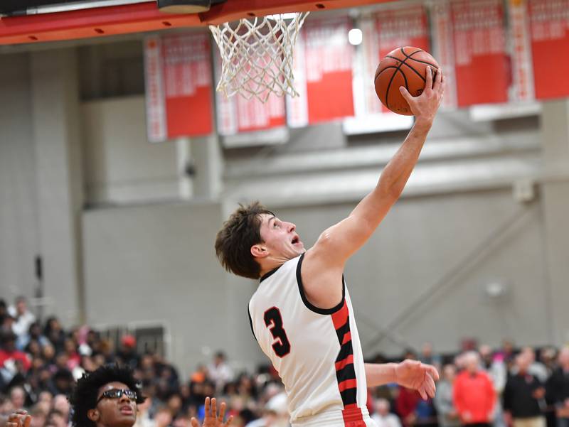 Benet's Brady Kunka (3) does a reverse layup during a "When Sides Collide" invitational game against Kenwood on Jan. 21, 2023 at Benet Academy in Lisle.