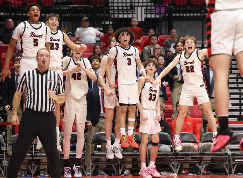 Benet players celebrate a late dunk Monday, March 9, 2026, during their IHSA Class 4A supersectional win over Auburn in the Convocation Center at Northern Illinois University in DeKalb.