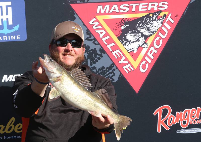 Ryan Feldott hold a a five-pound Walleye up during the National Walleye Tour Masters Walleye Circuit on Saturday, March 23, 2024 in Spring Valley.