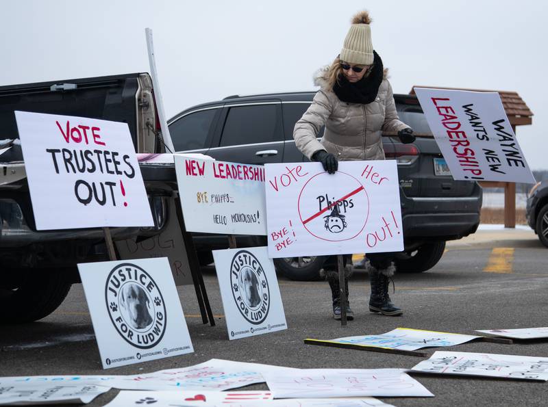 Melissa Bowers of Wayne lays out signs for protesters at the Wayne Depot prior to protesting at the Little Home Church by the Wayside to on Saturday, Jan. 7, 2023.