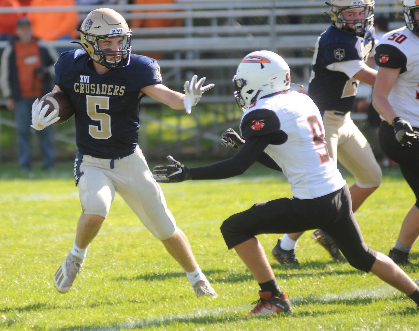 Marquette's Tom Durdan runs past Fisher's Cody Hiinton at Gould Stadium on Saturday, Oct. 23, 2021.