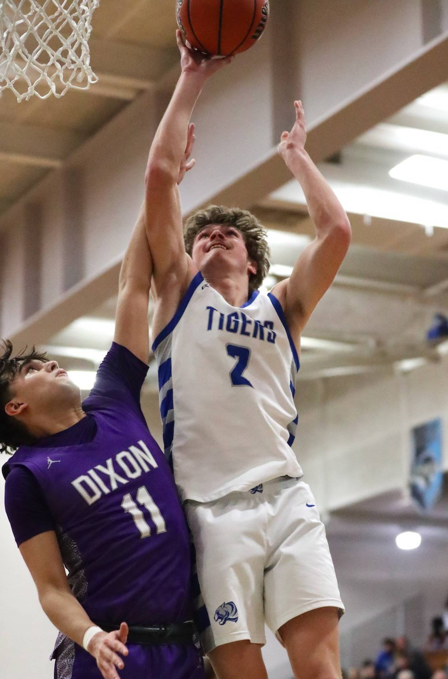 Princeton's Teegan Davis shoots over Dixon's Wyatt Wetzell Tuesday night at Prouty Gym. The Tigers won 60-52.