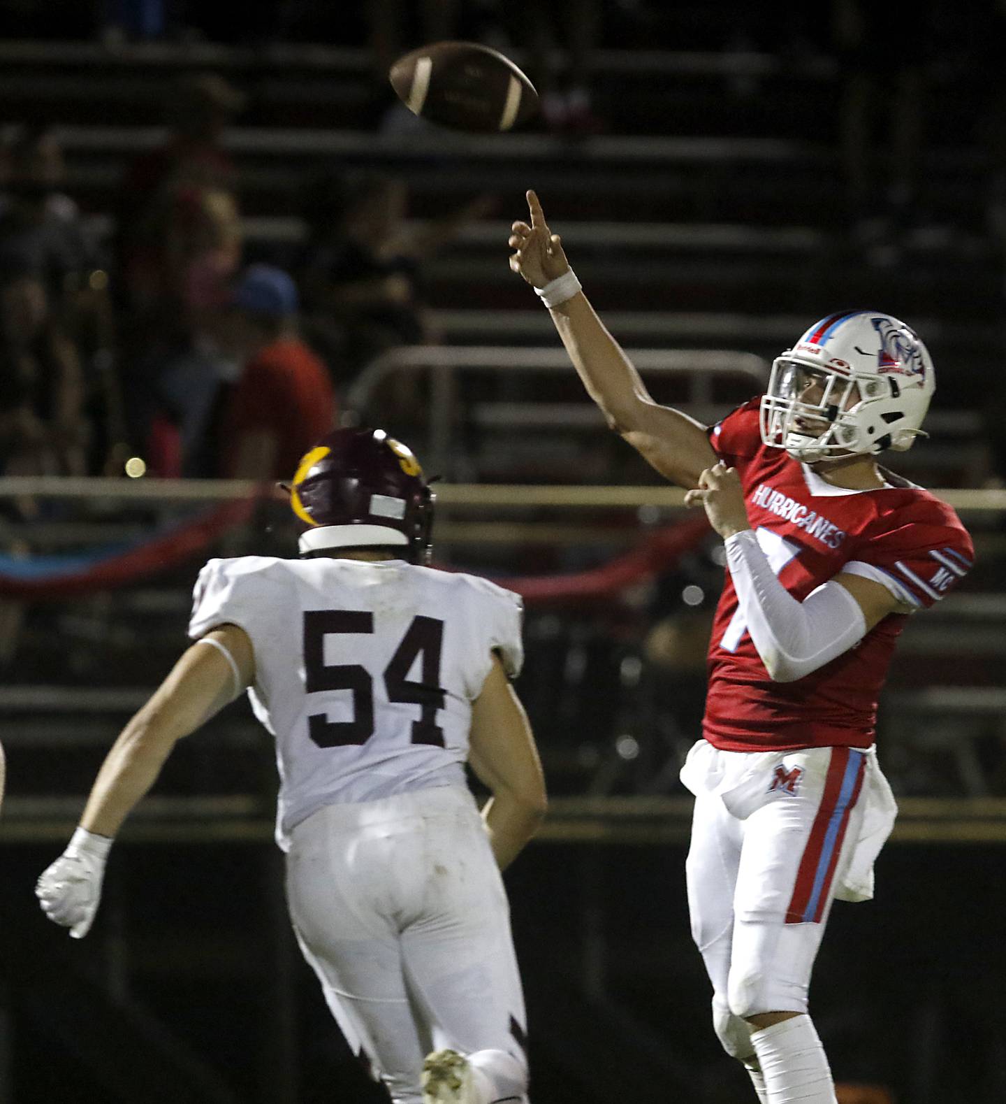 Marian Central's Cale McThenia passes the ball as he is pressured by Richmond-Burton's Luke Rendtorff during a nonconference football game Friday, Aug. 25, 2023, at Marian Central Catholic High School.