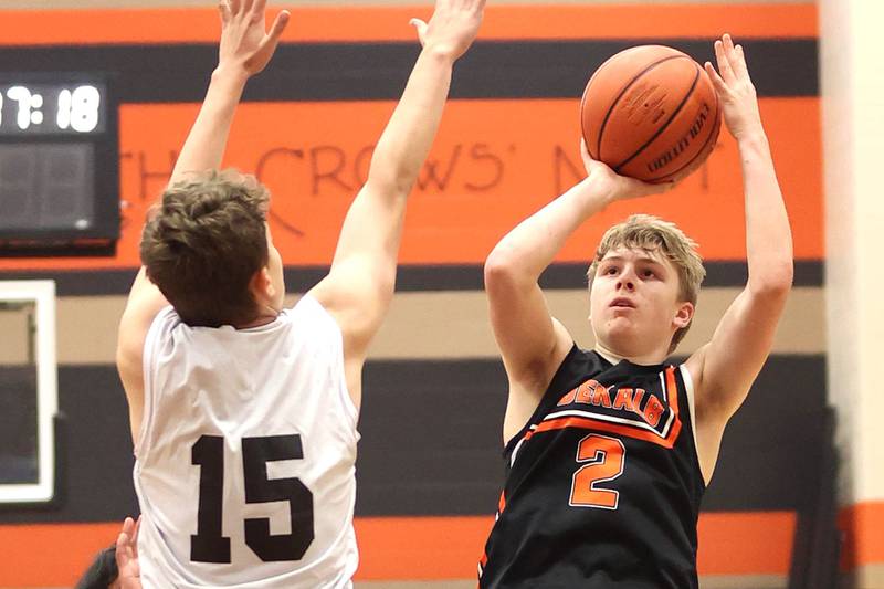 DeKalb's Sean Reynolds shoots over a defender during their game with Streamwood Tuesday, June 6, 2022, in a summer tournament at DeKalb High School.