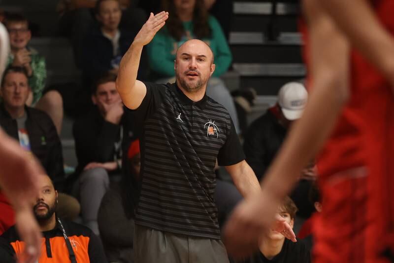 Minooka head coach Brett Hespell singles to his players against Bolingbrook on Tuesday, Dec. 17, 2024 in Minooka.