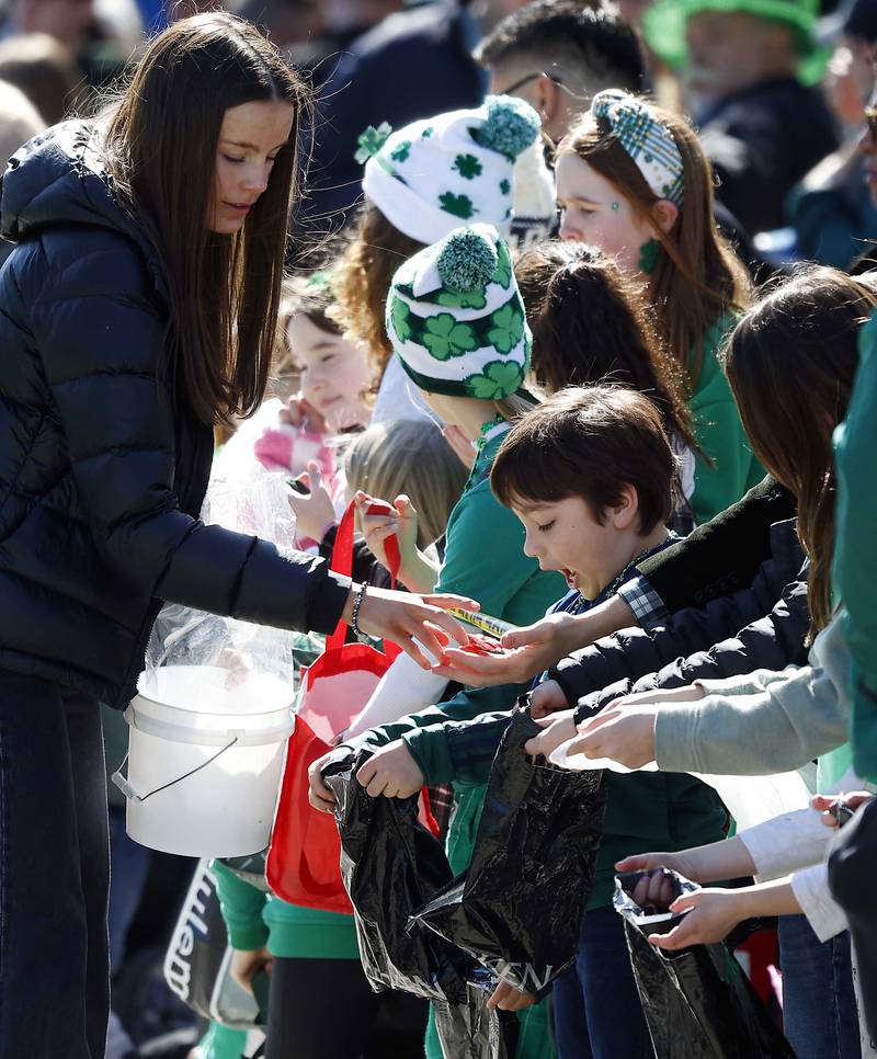 Children rush to collect candy during the annual St. Patrick’s Day Parade Saturday, March 8, 2025 in Elmhurst Ill.