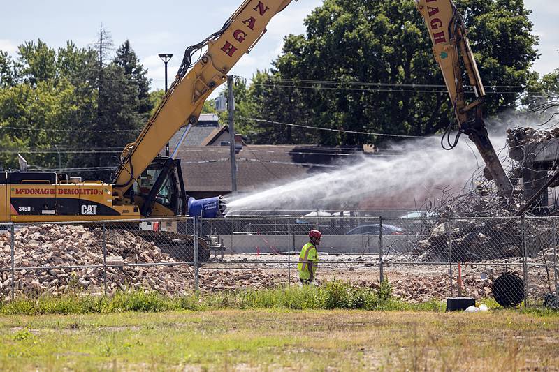 A constant spray of water keeps the dust at bay Wednesday, Aug. 21, 2024 as demolition of the Micro building continues in Rock Falls.