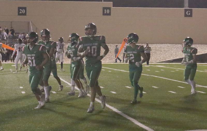 Members of the L-P football team jog off of the field at halftime after a stadium light went out on Friday, Sept. 5, 2025 at Howard Fellows Stadium.